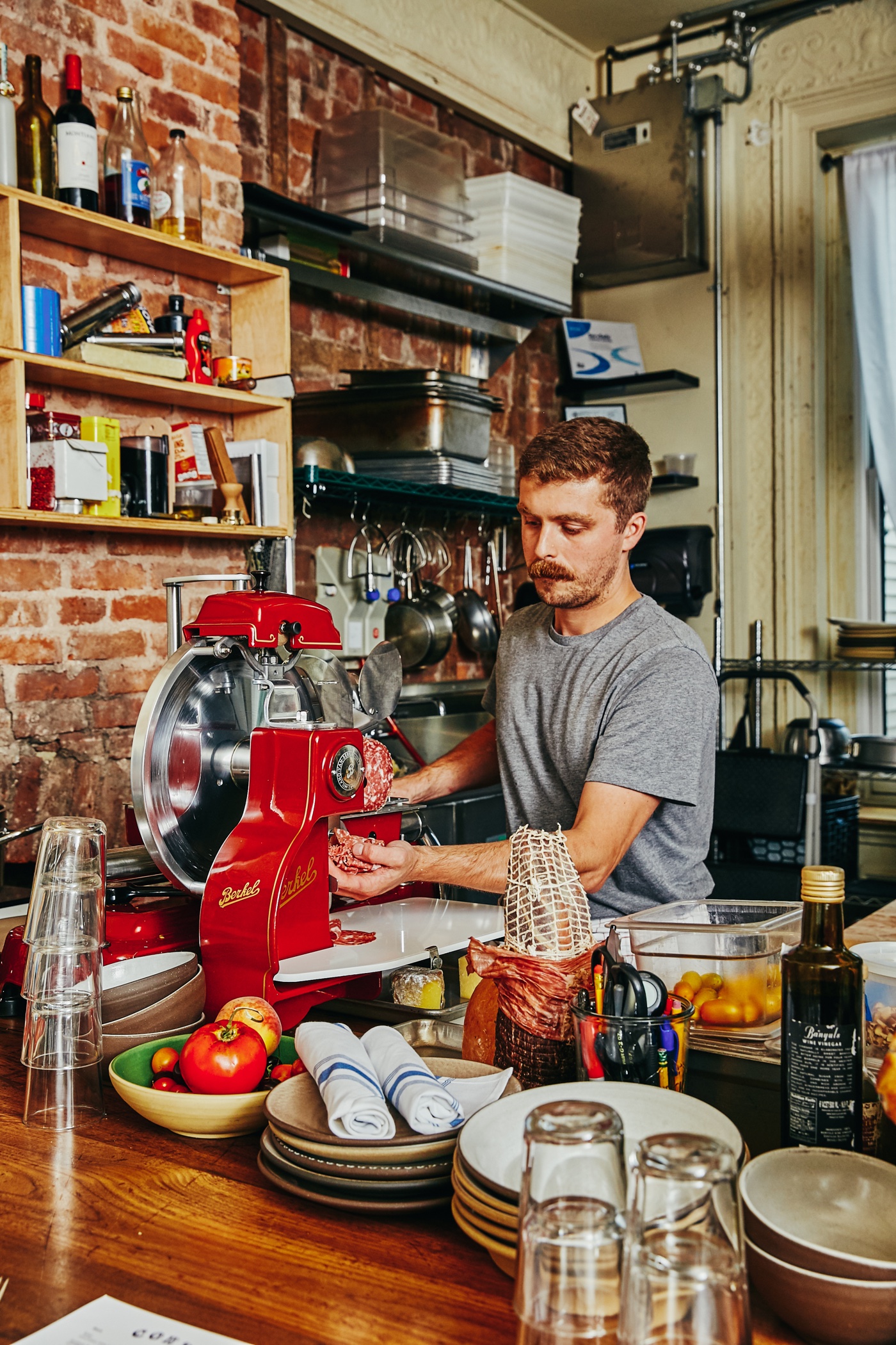 Matt Moschella slicing salumi in the Corto kitchen